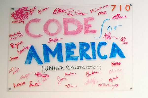 Hand-painted "Code for America (under construction)" sign signed by fellows