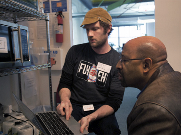 Two people pair programming at a hackathon