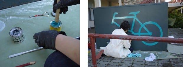 Volunteers painting bike storage units